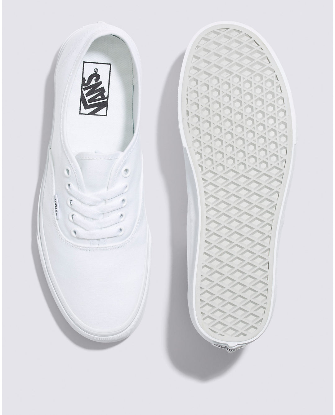 Vans Authentic low-top sneakers in a classic canvas design, featuring sturdy uppers in seasonal colors. The iconic rubber waffle outsole and lace-up closure provide a timeless look for creative and casual styles. True White color and Top and bottom angle view.