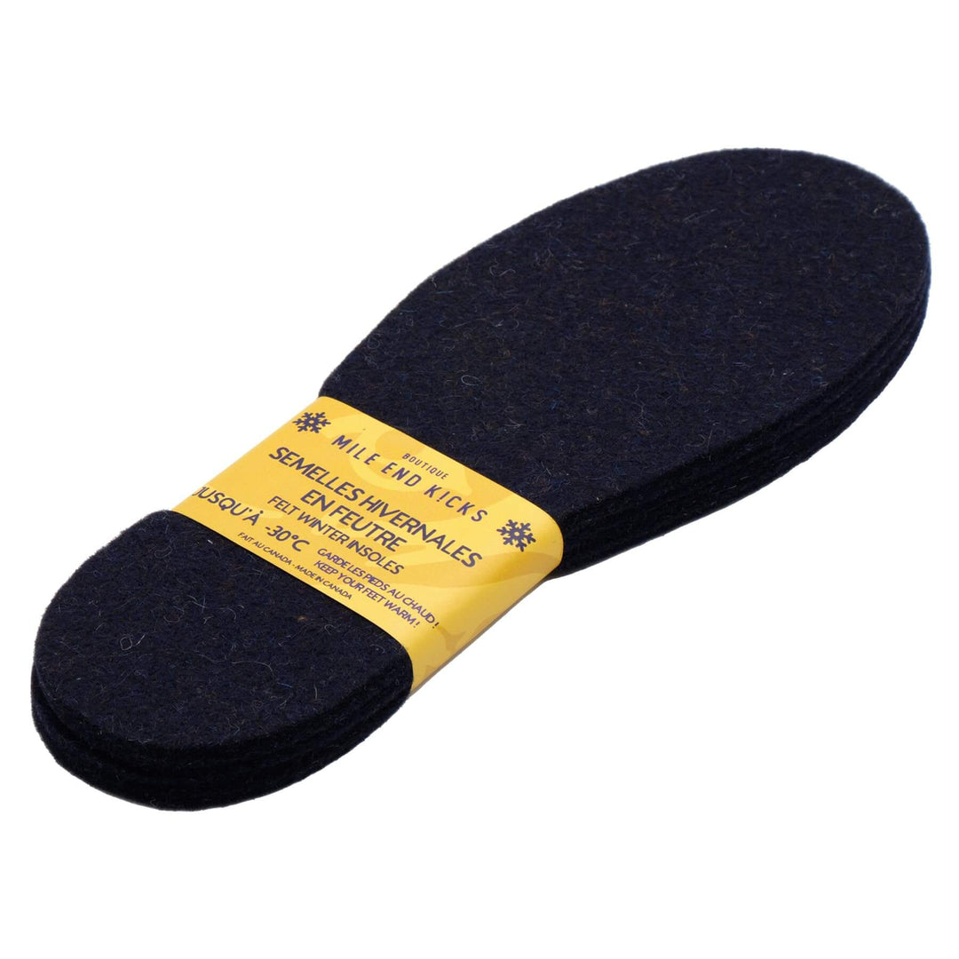 A set of black wool felt insoles with a yellow label showing product details.