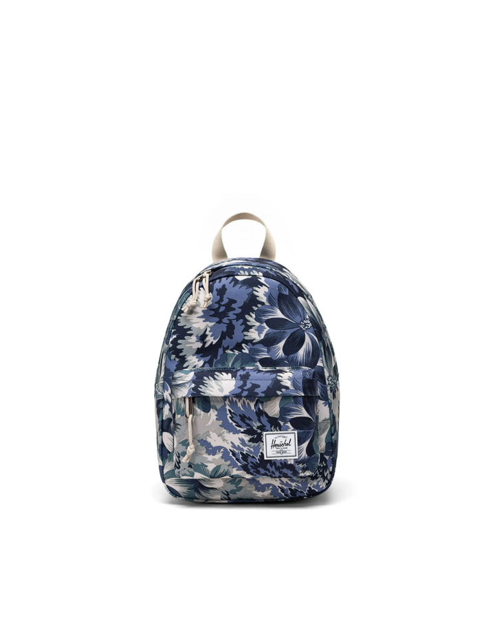 A compact floral Herschel Classic Mini Backpack with front pocket and brand label visible.