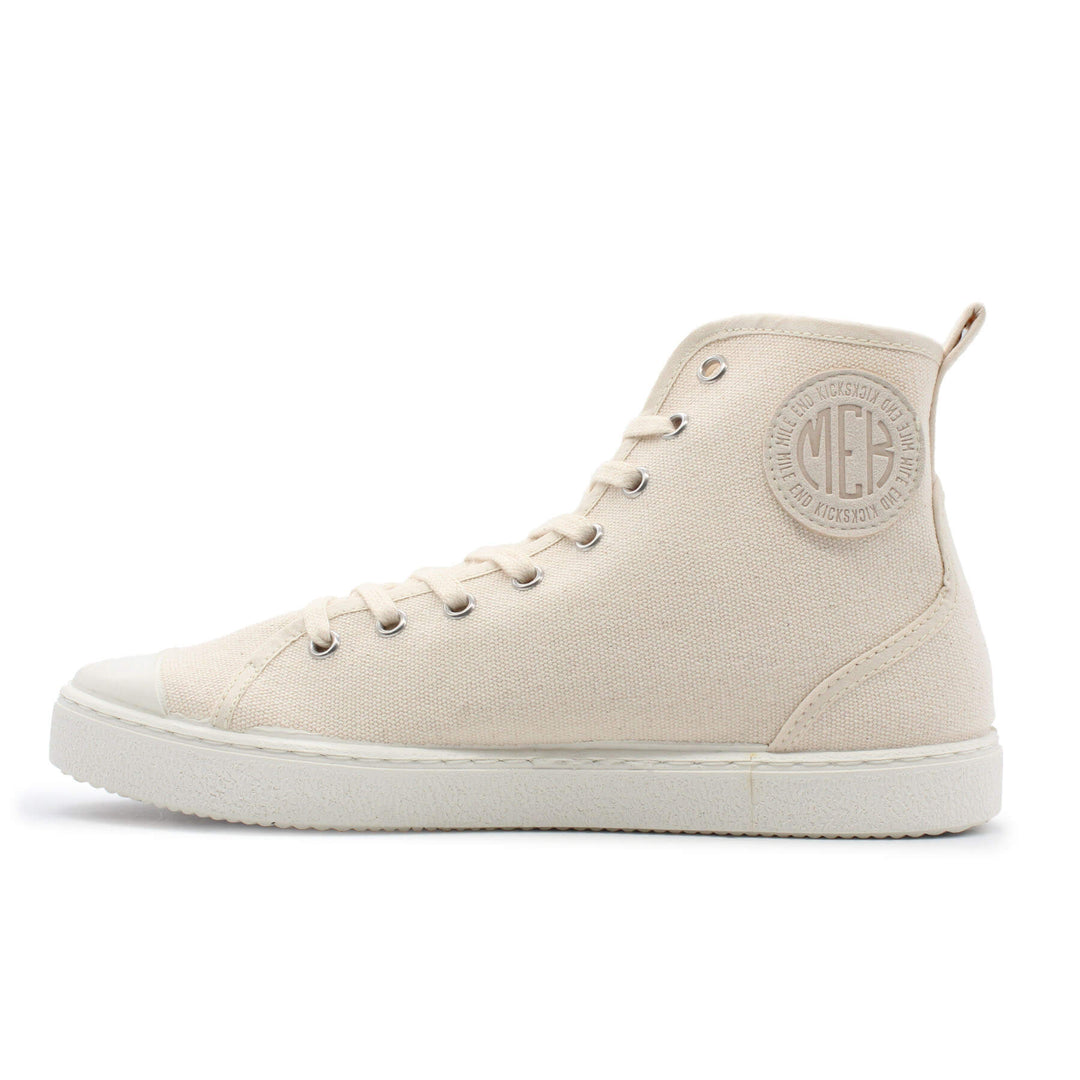 A cream colored canvas high top shoe. There is a circular path near the heel with a logo on it.