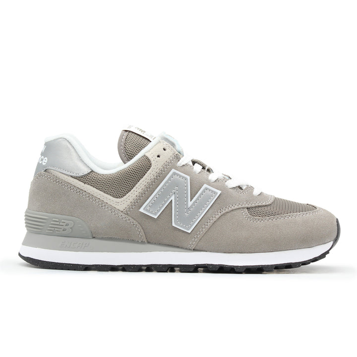 A grey and white sneaker with suede and mesh.