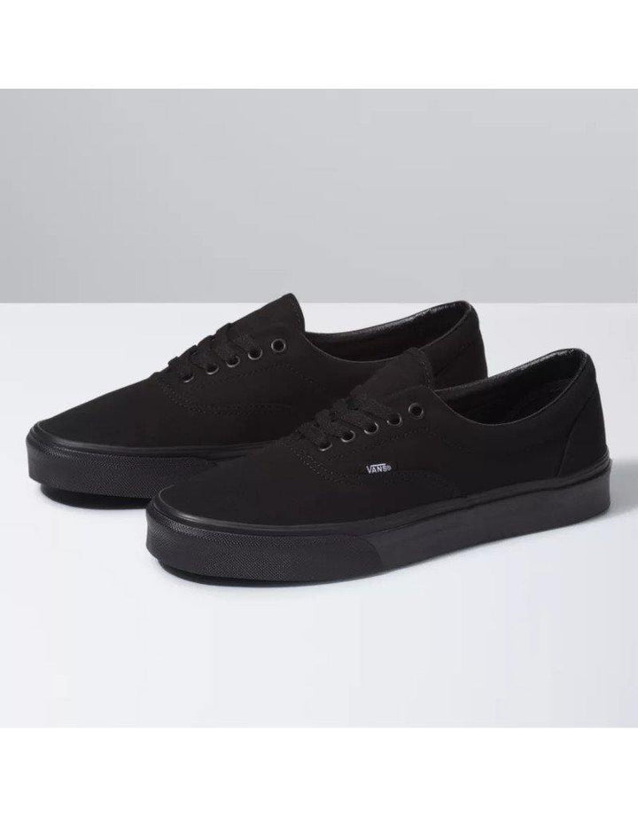 Vans Era Skate Shoe - Legendary low-top design with padded collars, sturdy canvas uppers, metal eyelets, and signature rubber waffle outsoles. A symbol of skate and street culture since 1976. Black/black color and shoes facing left