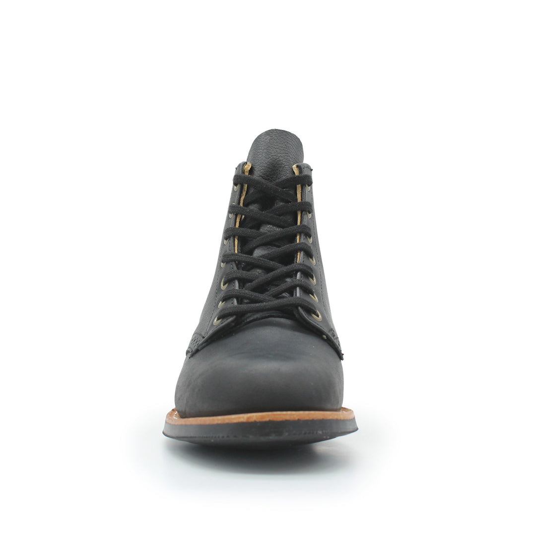 Black leather boot with brown sole on a white background