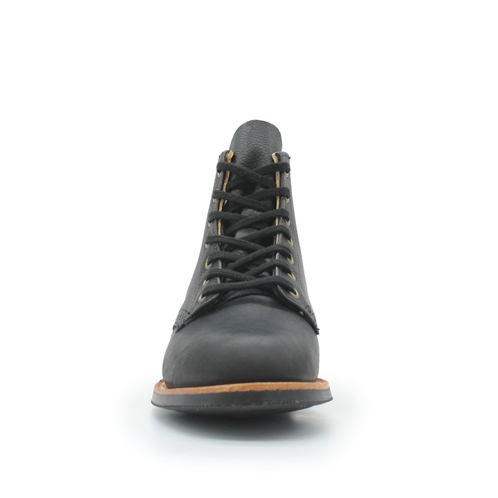 Black leather boot with brown sole on a white background