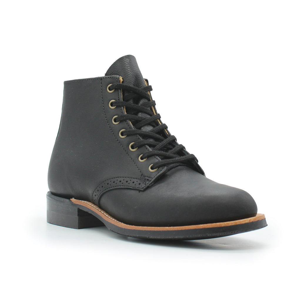 Black leather boot with brown sole on a white background