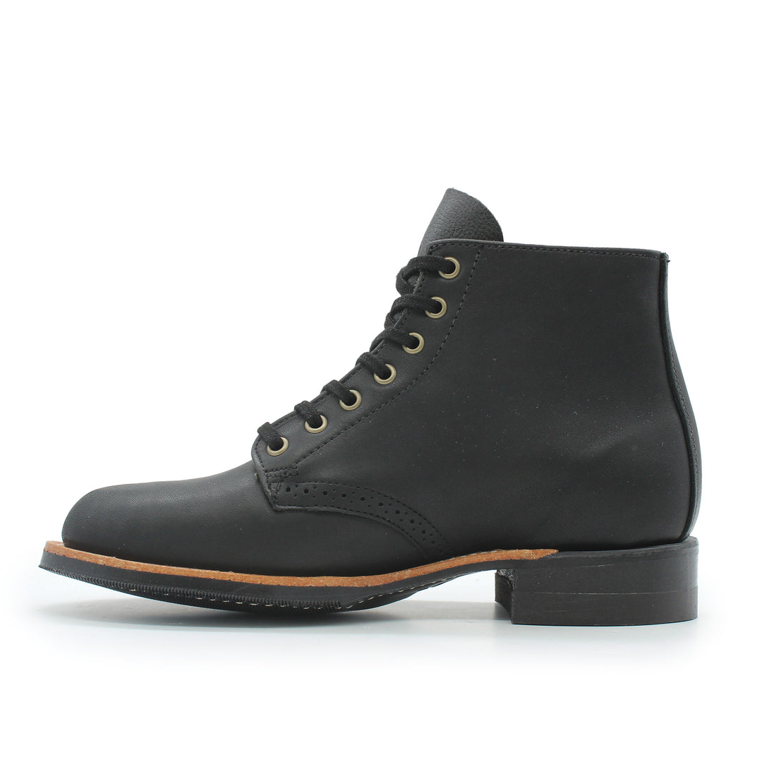 Black leather boot with brown sole on a white background
