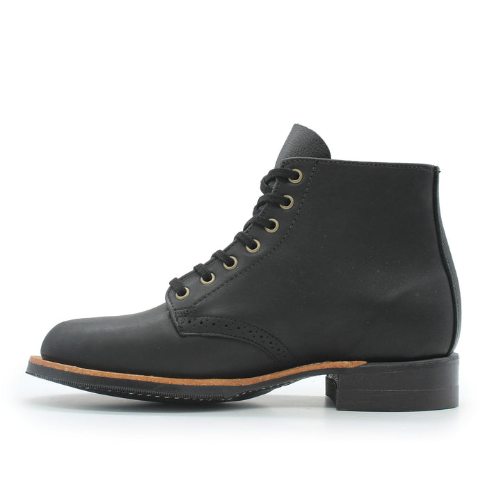 Black leather boot with brown sole on a white background