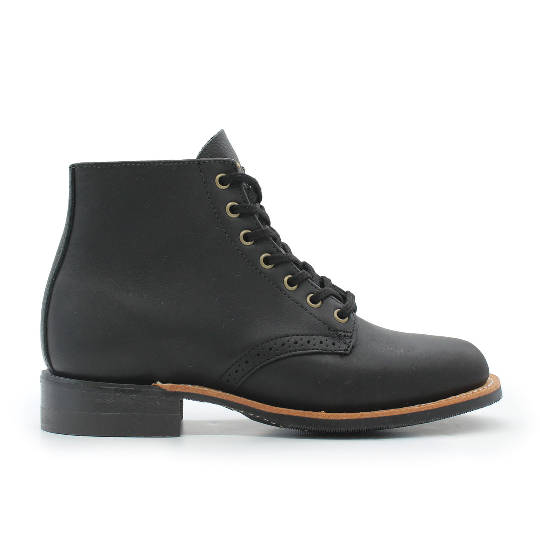 Black leather boot with brown sole on a white background