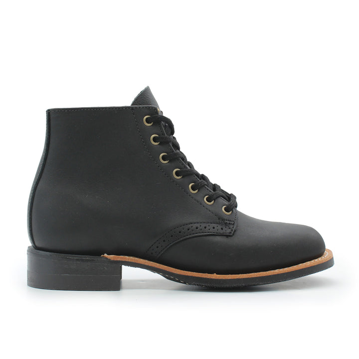 Black leather boot with brown sole on a white background