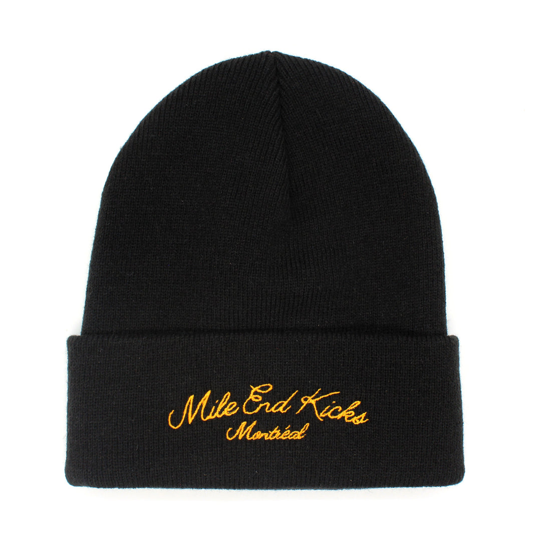 Black beanie with yellow embroidered text on a white background