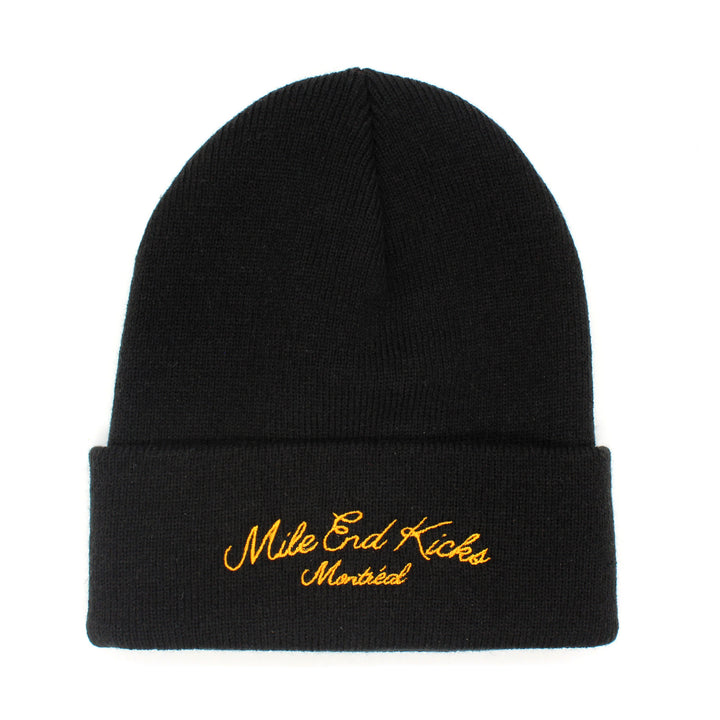 Black beanie with yellow embroidered text on a white background