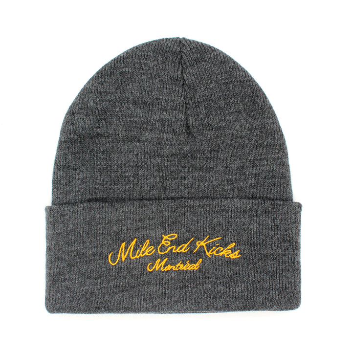 Gray beanie with yellow embroidered text on a white background
