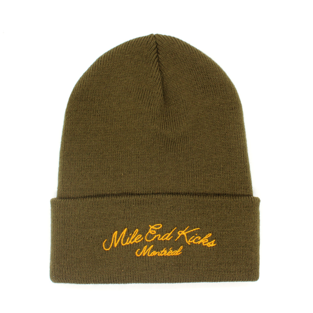 Green beanie with yellow embroidered text on a white background