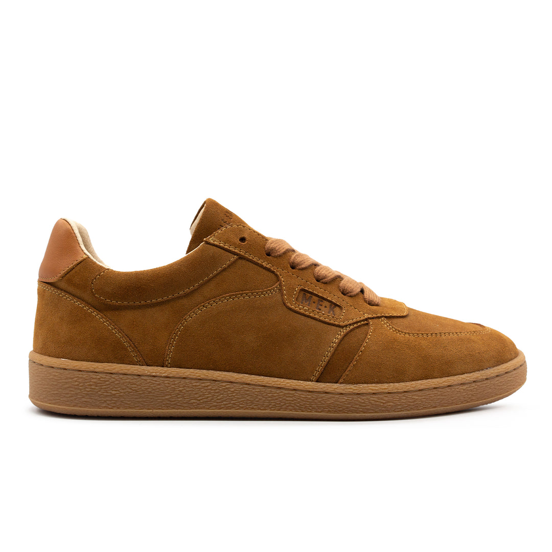 A brown suede low top sneaker with a gum sole.