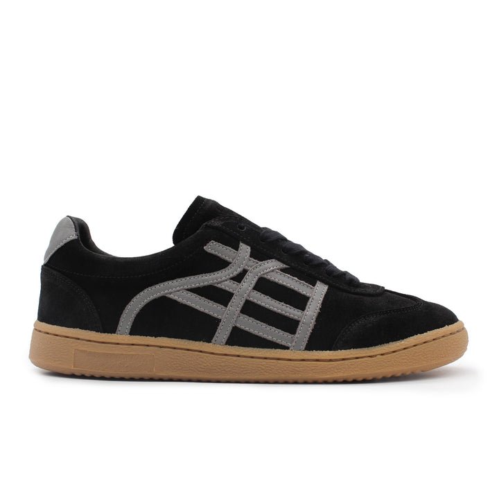 A black and grey suede sneaker with a gum sole.