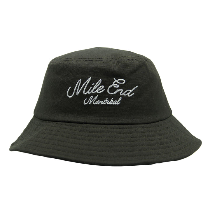Green bucket hat with 'Mile End Montreal' embroidery on a white background