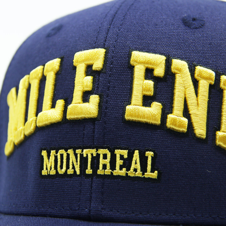 Navy blue cap with yellow embroidered text 'MILE END MONTREAL'