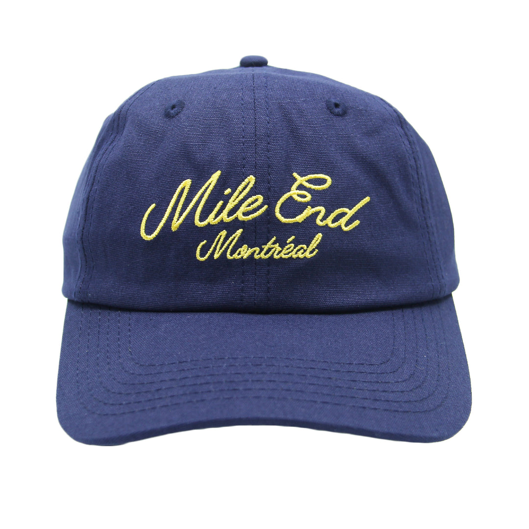 Blue cap with yellow text 'Mile End Montreal' on a white background