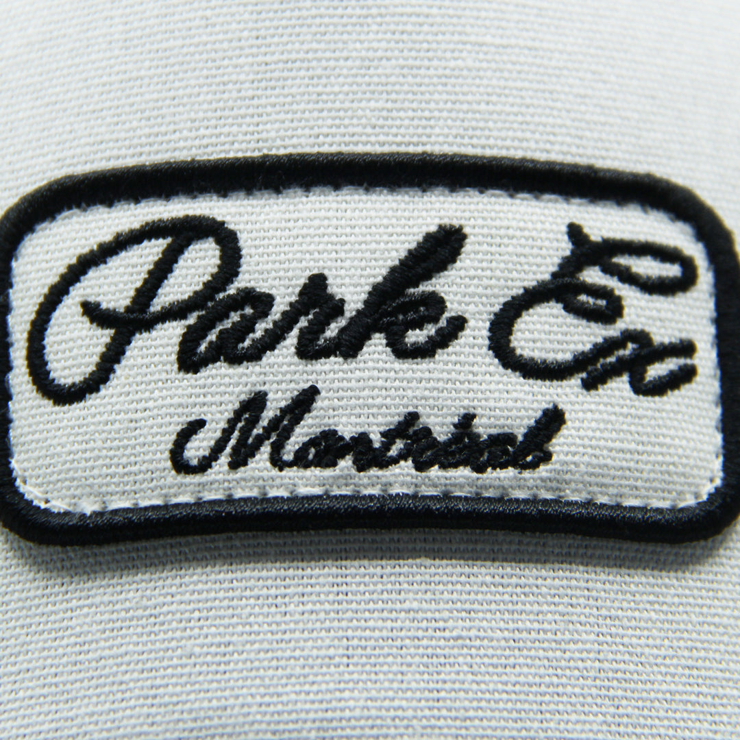 Embroidered patch with 'Parks Ex Montreal' text on a hat on a white background