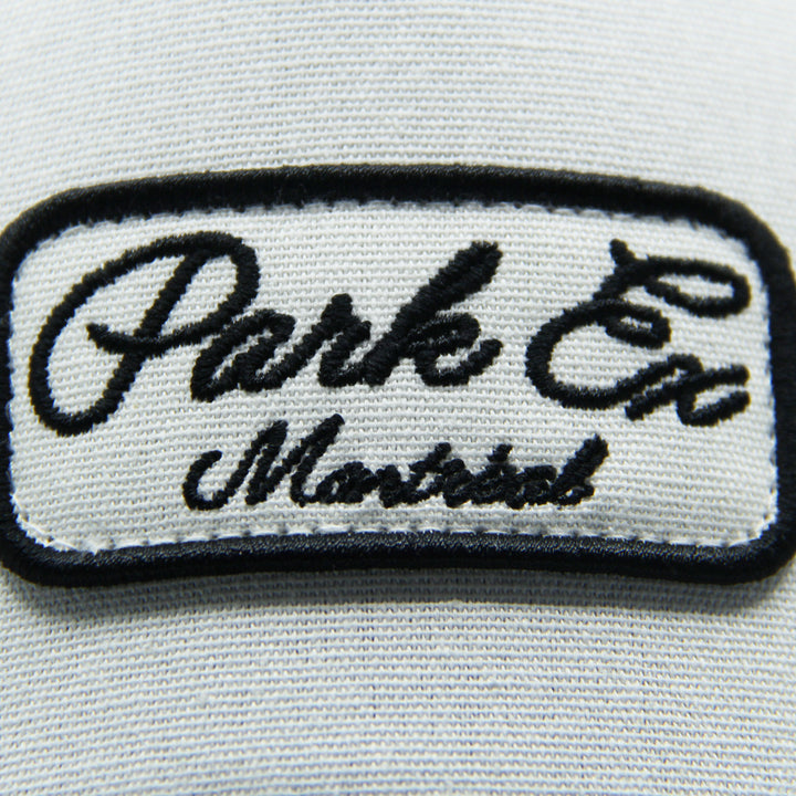 Embroidered patch with 'Parks Ex Montreal' text on a hat on a white background