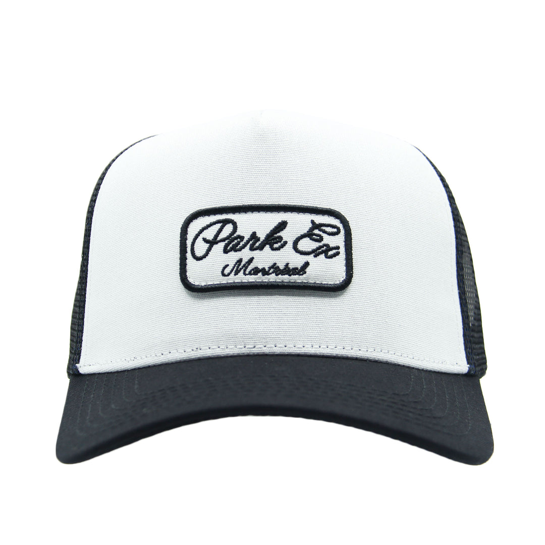 White and black trucker hat with 'Park Ex Montreal' logo on a white background