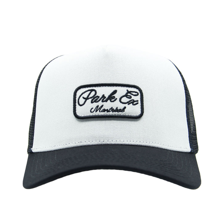 White and black trucker hat with 'Park Ex Montreal' logo on a white background