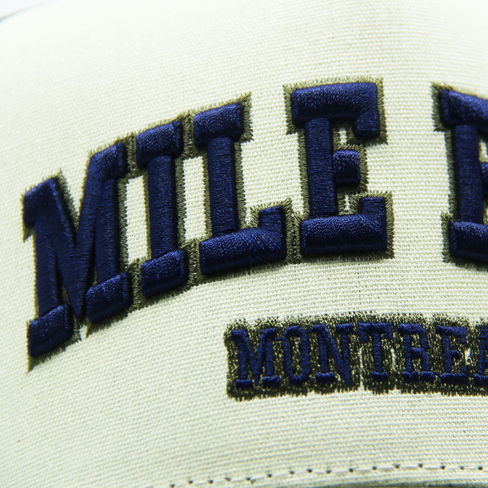 Close-up of a cap with 'Mile End Montreal' embroidered on it.