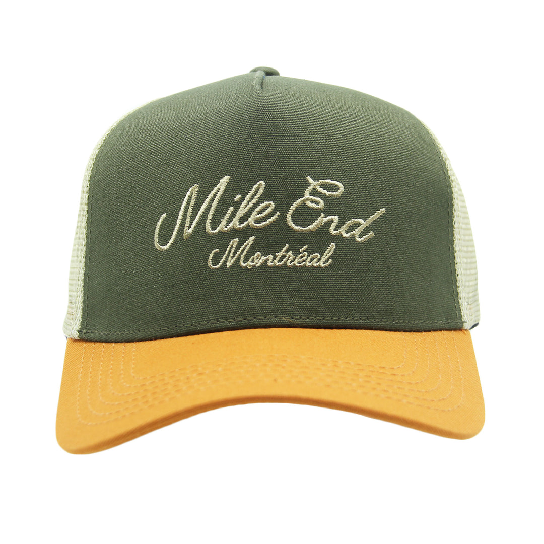 Green and yellow cap with 'Mile End Montreal' embroidery on a white background