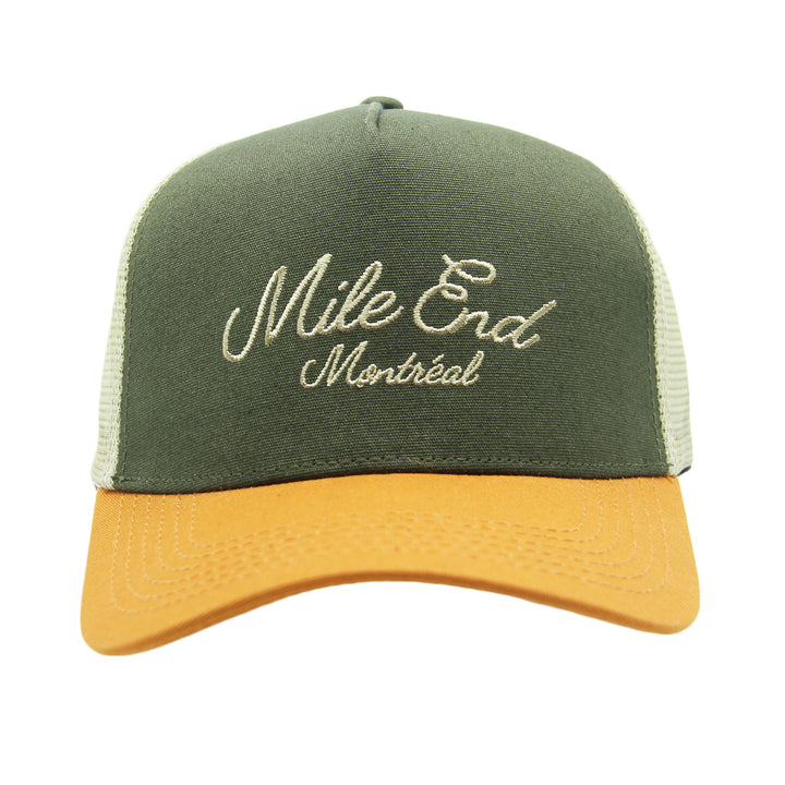 Green and yellow cap with 'Mile End Montreal' embroidery on a white background