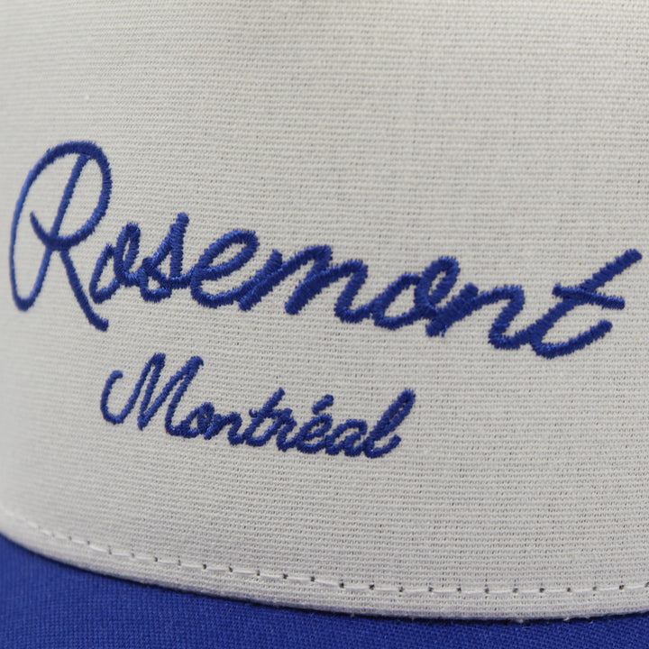 White cap with blue embroidered text 'Rosemont Montreal' on a white background