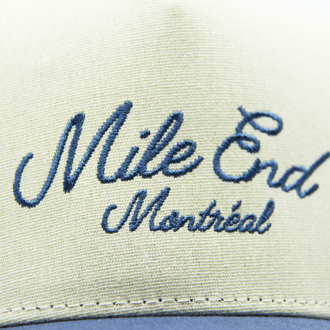 Cap with 'Mile End Montreal' embroidery on a white background