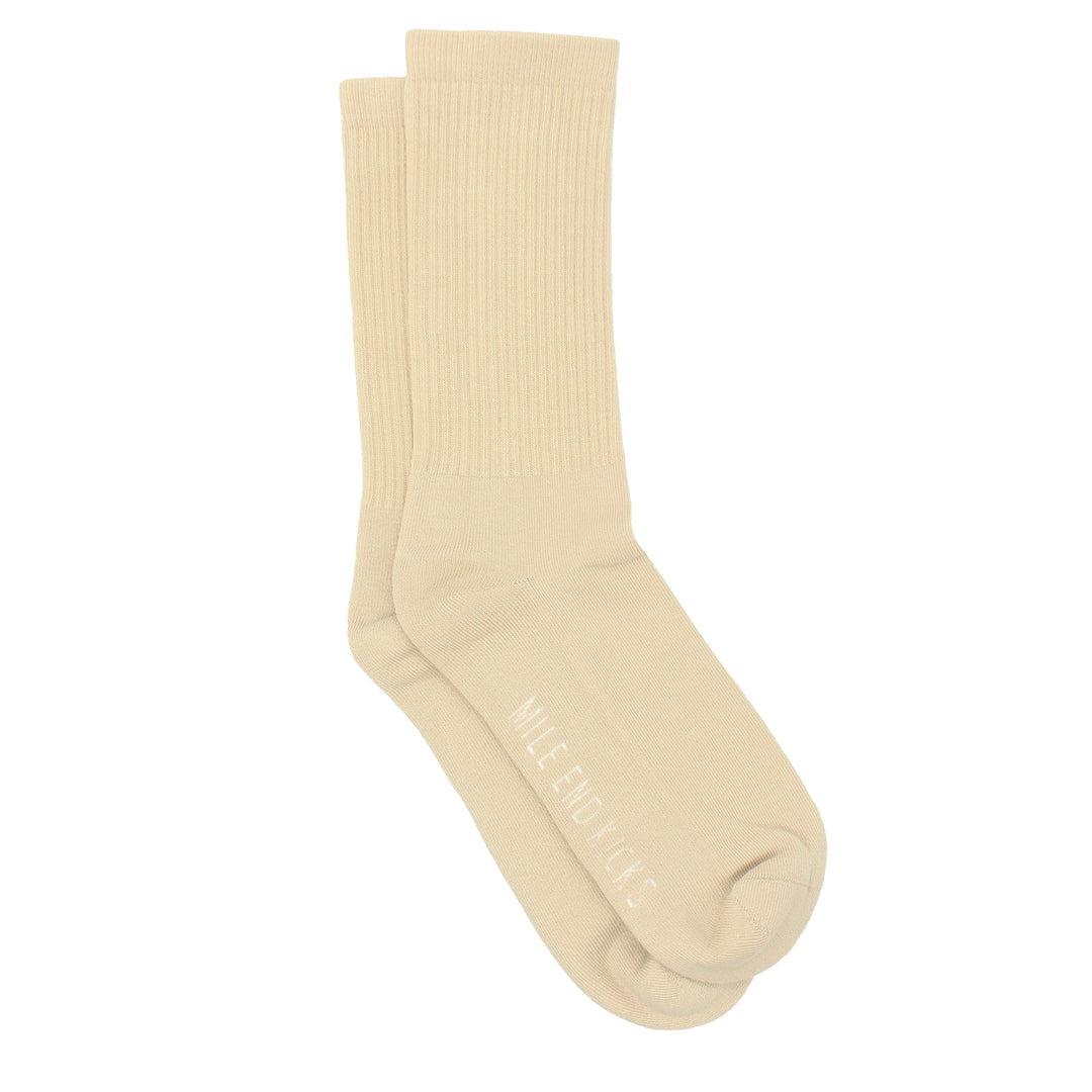 Pair of beige socks on a white background