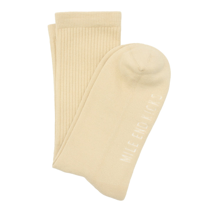 Pair of beige socks on a white background