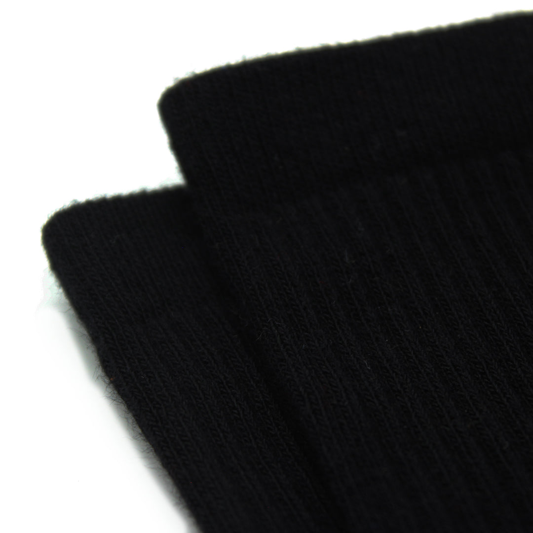 Close-up of two black socks on a white background
