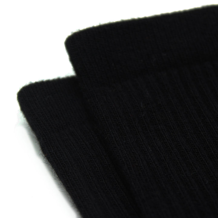 Close-up of two black socks on a white background