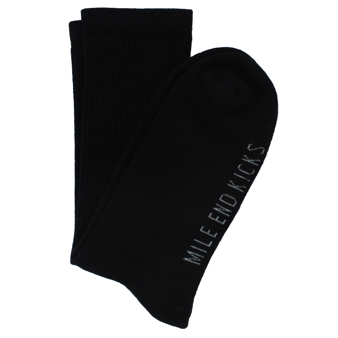 Black socks with 'Mile End Kicks' branding on a white background