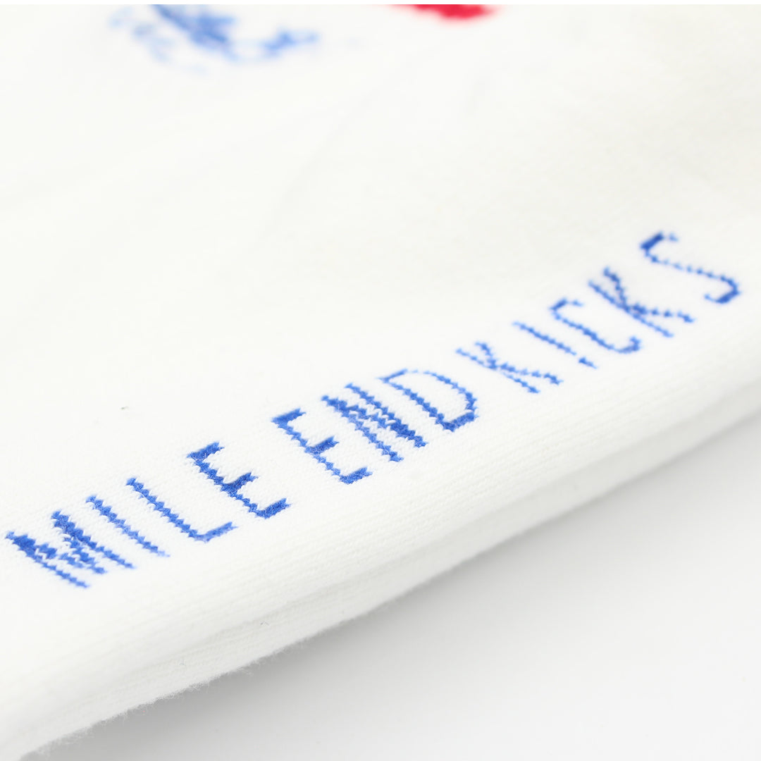 Close-up of white socks with blue text on a white background