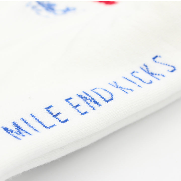 Close-up of white socks with blue text on a white background