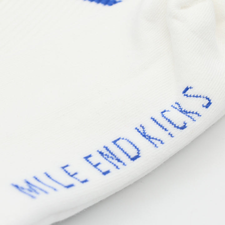 Close-up of white socks with blue text on a white background