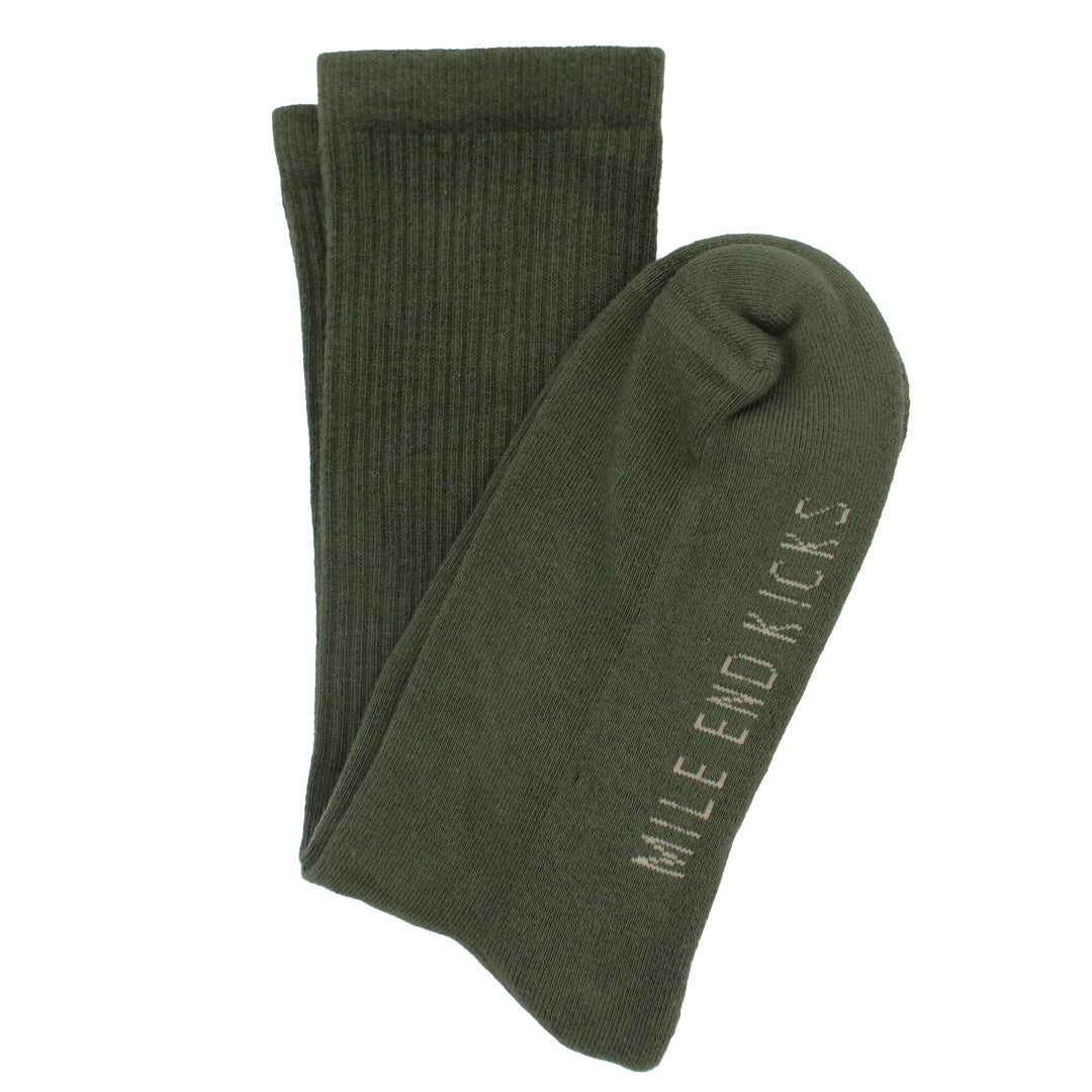 Green socks with 'Mile End Kicks' branding on a white background