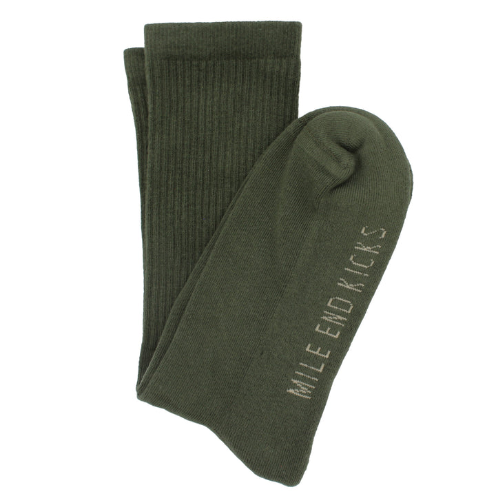 Green socks with 'Mile End Kicks' branding on a white background