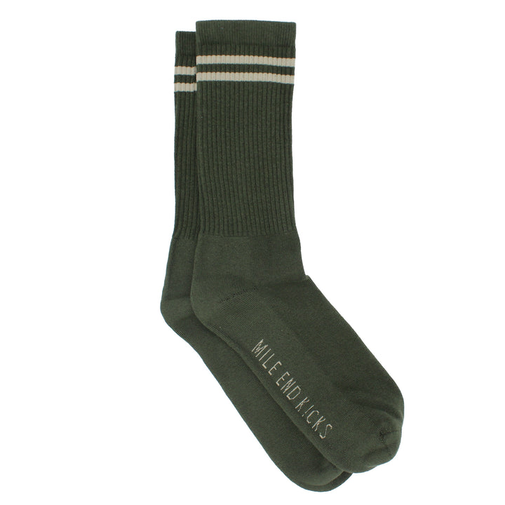Green sock with a white stripe on a white background