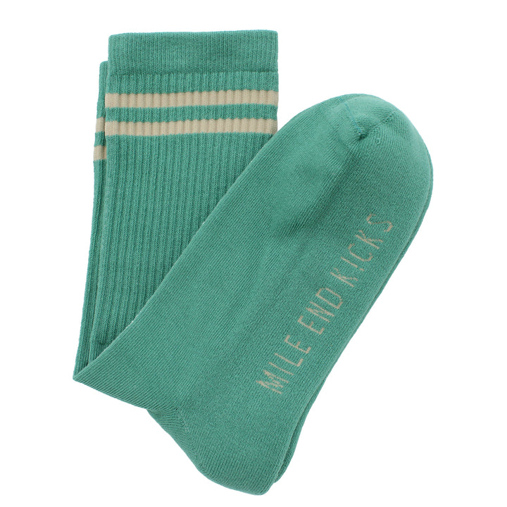 Green sock with beige stripe and 'Mile End Kicks' branding on a white background