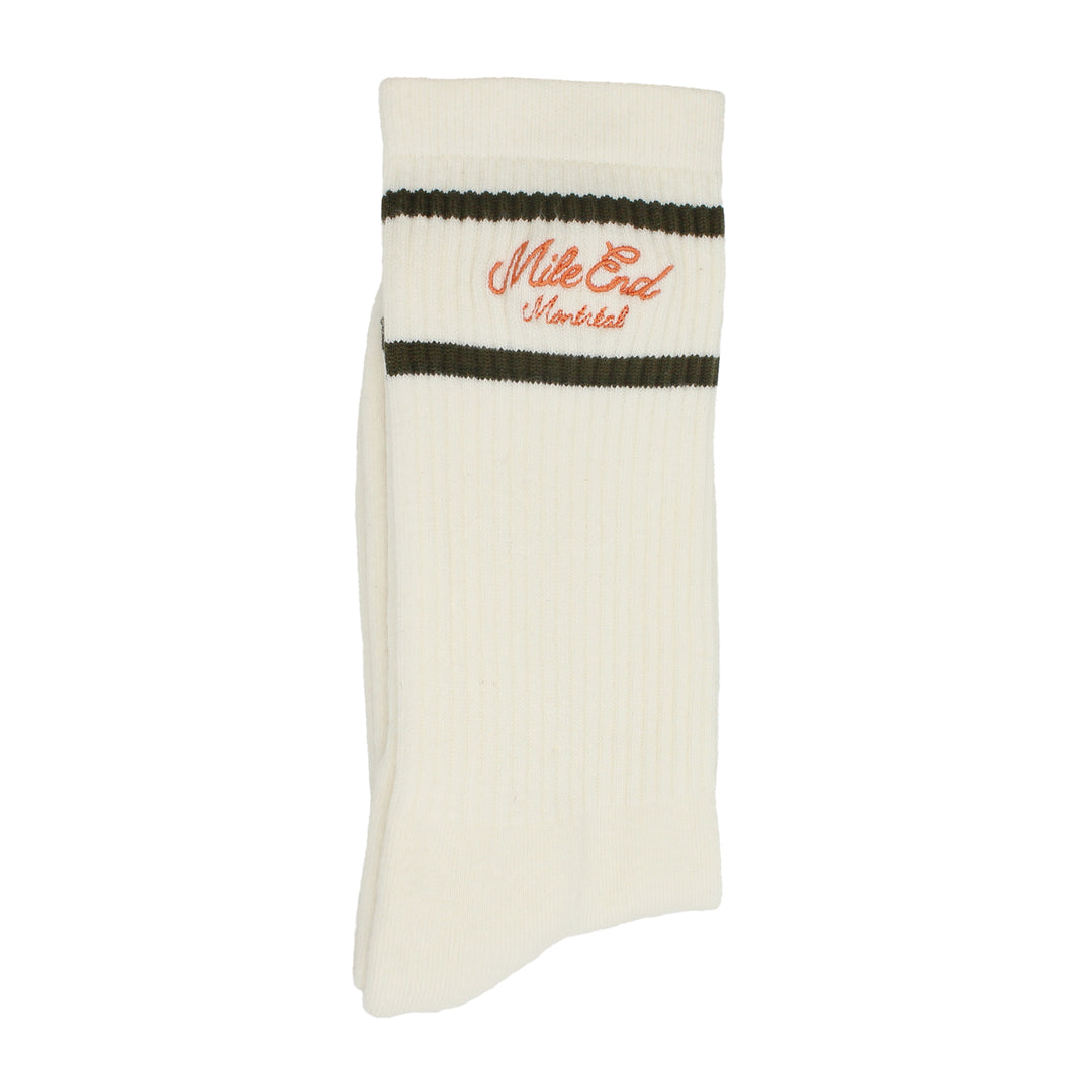 White sock with green stripes and orange text on a white background