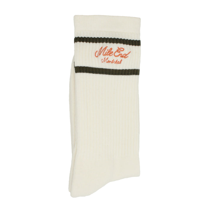 White sock with green stripes and orange text on a white background