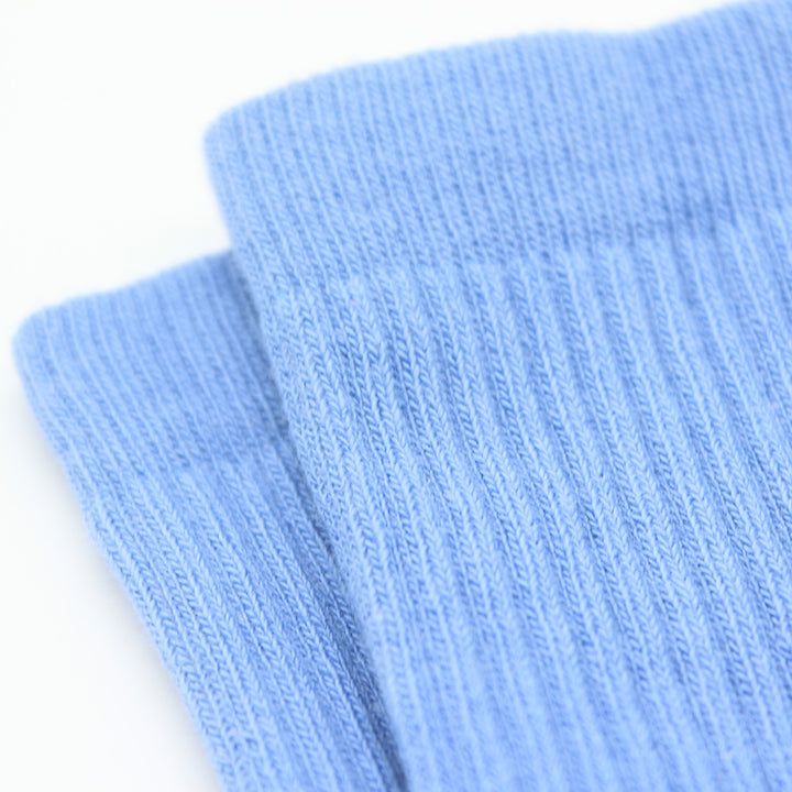 Two light blue socks on a white background