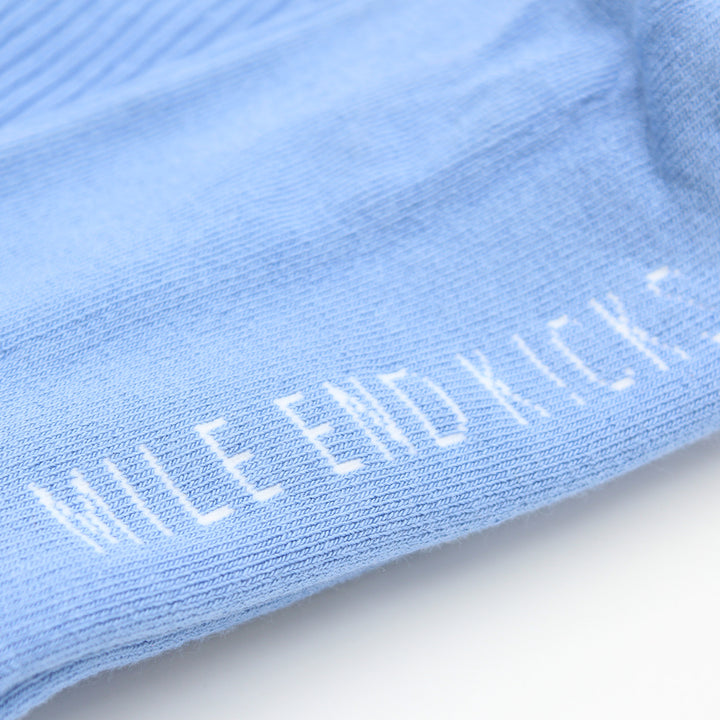 Close-up of a light blue sock with 'MILE END KICKS' embroidered on it.
