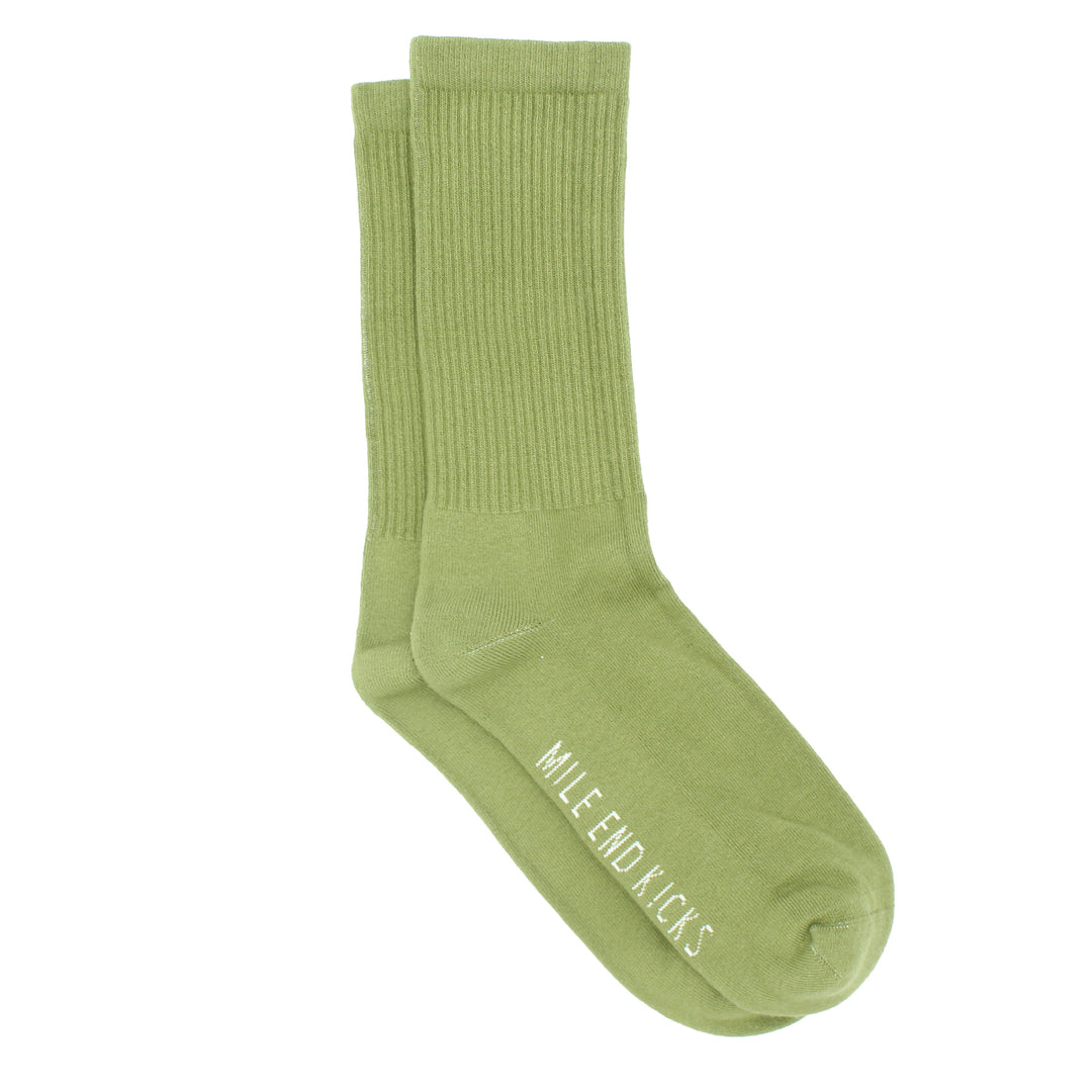 Green sock with 'Mile End Kicks' branding on a white background