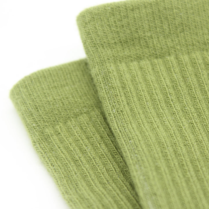 Two green socks on a white background