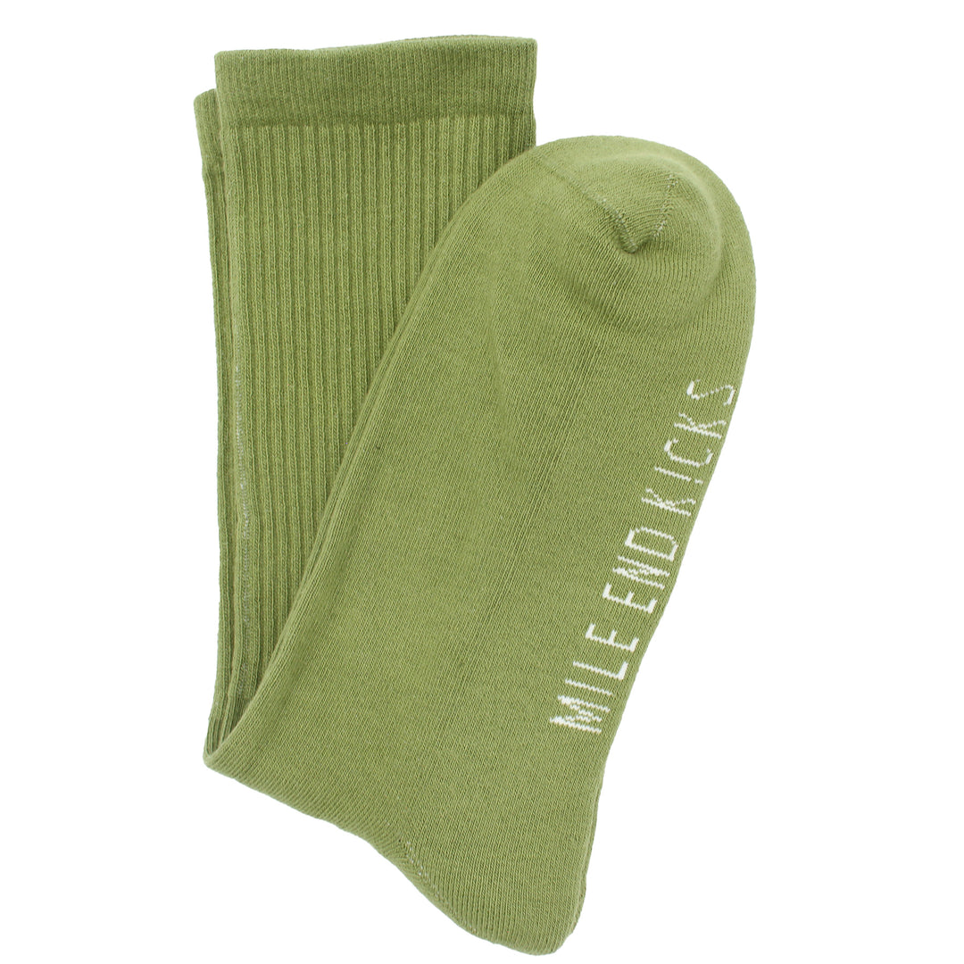 Green socks with 'Mile End Kicks' branding on a white background